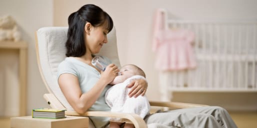 Mother bottle feeding baby