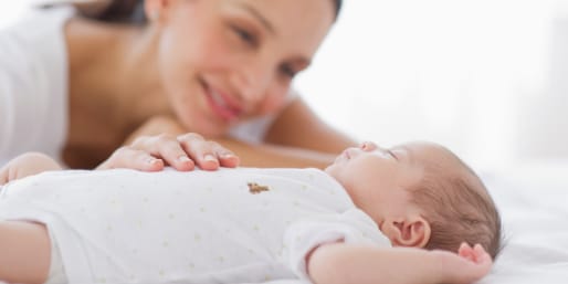 Mother watching over sleeping baby