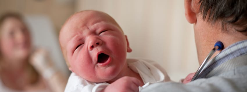 Mother and baby with healthcare professional