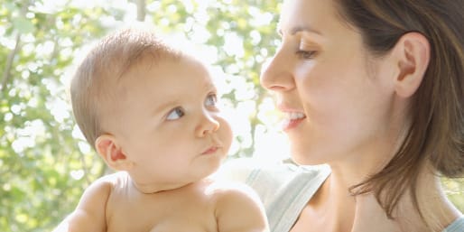 Mother holding baby child in the sunshine, a natural source of vitamin D