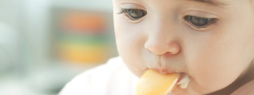 Baby eating with a spoon