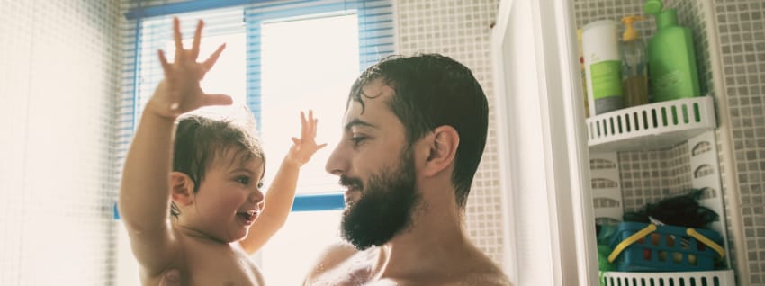 Father and toddler in shower