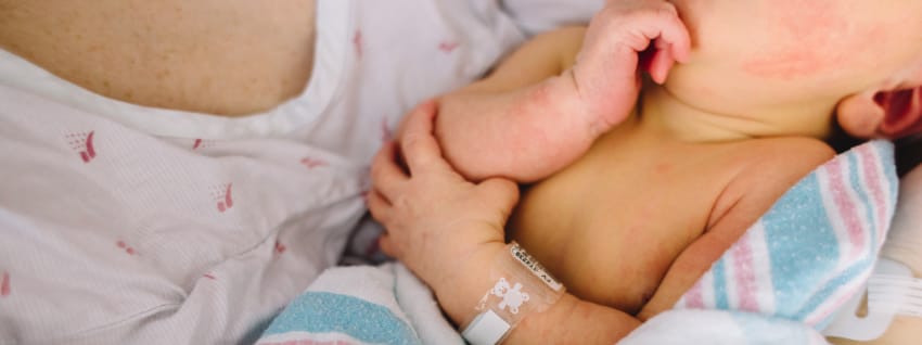 Mother holding preterm baby