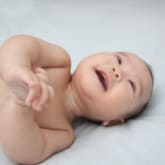 Baby smiling and looking up