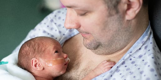father-holding-newborn