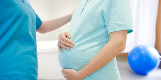 Healthcare professional supporting a pregnant mother