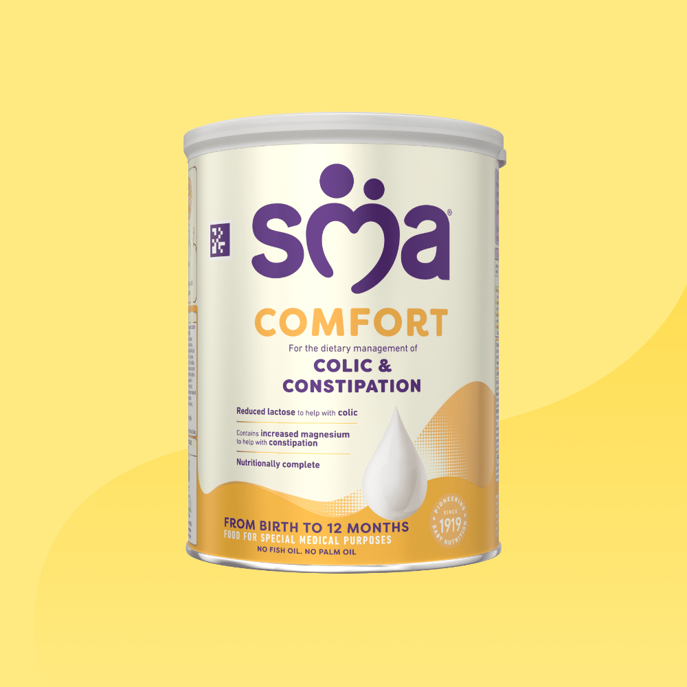 Tin of of SMA Comfort Formula Powder with a grey lid, on a yellow background 
