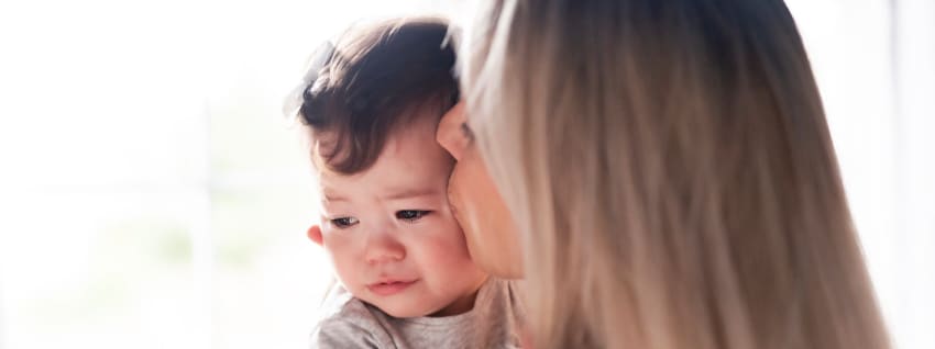 Mother holding and comforting baby