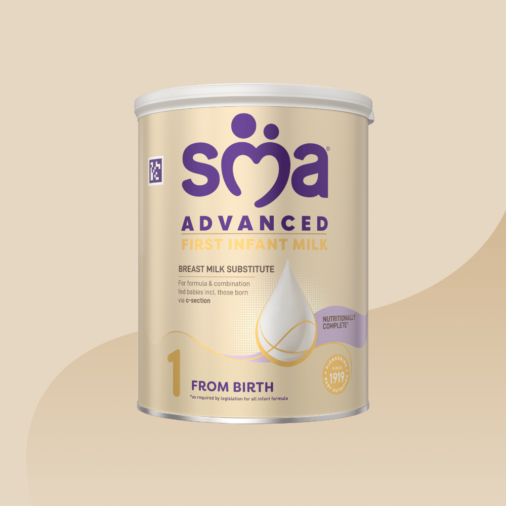Tin of SMA Advanced First Infant Milk for babies 0-6 months with a grey lid on a gold background