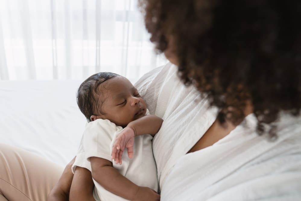Mother holdling sleeping baby