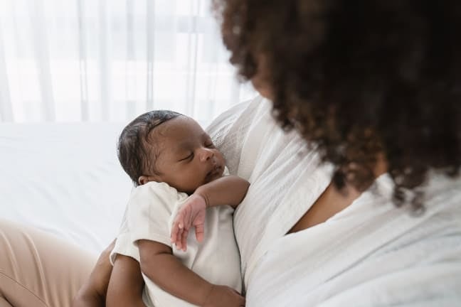 Mother holdling sleeping baby
